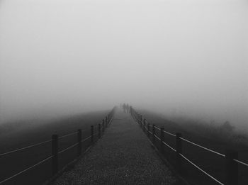 Road against clear sky during foggy weather