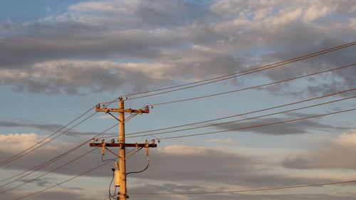 Low angle view of electricity pylon against sky