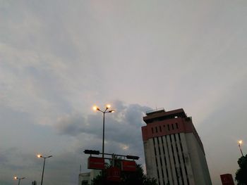 Low angle view of building against cloudy sky