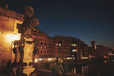 Illuminated buildings against sky in city at night