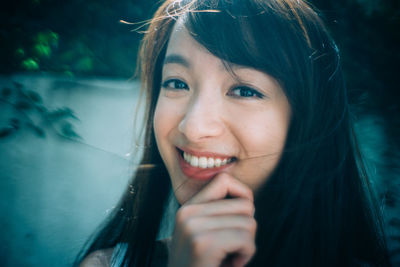 Close-up portrait of a smiling young woman