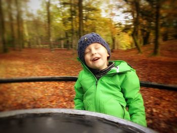 Boy enjoying on merry-go-round in park