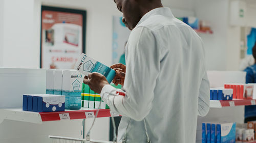 Rear view of doctor working at office