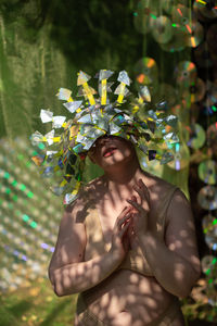 Portrait a woman in a reflective mask in a beige bikini on a cd / dvd case of scenery in the forest