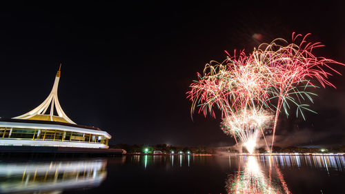 Firework display over river at night