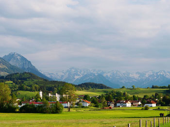 Tranquil landscape in sunshine against mountains in shadows