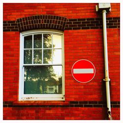 Road sign on wall of building