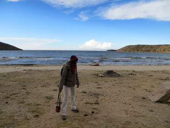 Rear view of man standing on beach