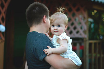 Side view of mother and daughter at home