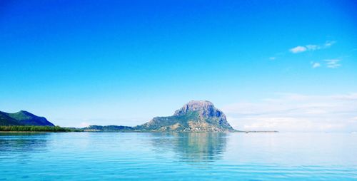 Scenic view of sea against clear blue sky