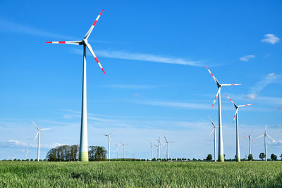 Windmill on field against sky