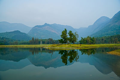 Scenic view of lake and mountains against sky