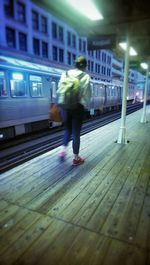 Blurred motion of woman standing on city street