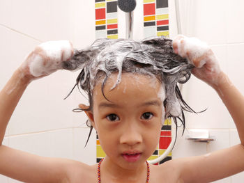 Close-up portrait of girl in bathroom