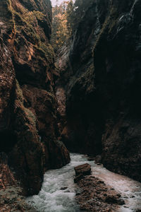 Rock formation amidst waterfall