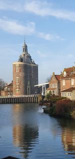 Ancient tower reflected in the water of the canal