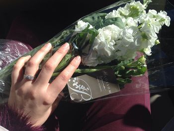 Close-up of hand holding flower bouquet