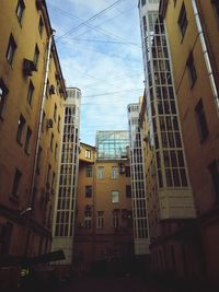 Low angle view of buildings in city against sky