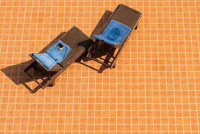 High angle view of tiled floor against brick wall