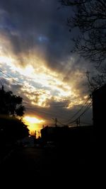 Silhouette city against sky during sunset