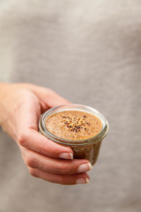 Midsection of woman holding food in container