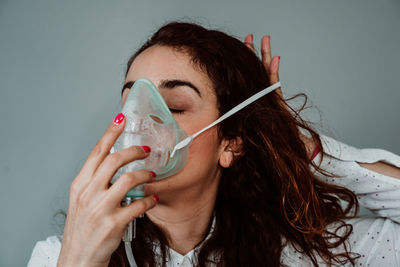 Portrait of young woman drinking drink