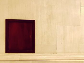 Red door on wooden wall