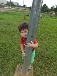 Portrait of cute boy playing on field