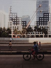 Man riding bicycle on city street