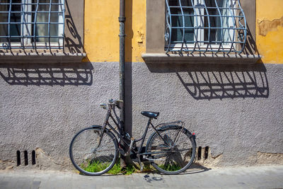 Bicycle parked against building