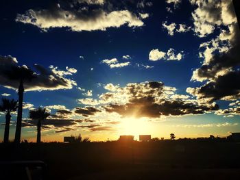 Silhouette buildings against sky during sunset
