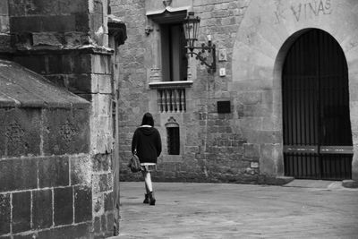 Rear view of woman standing in building