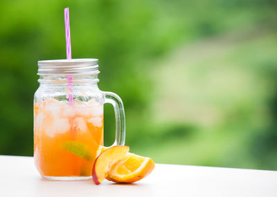 Close-up of drink in glass jar on table