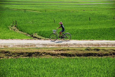 Man riding bicycle on field