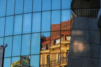 Low angle view of modern building against blue sky