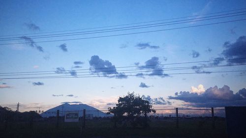 Silhouette of trees on landscape against sky