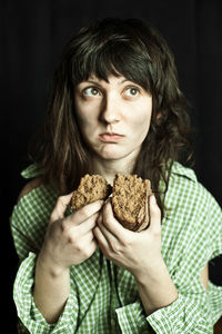 Portrait of a poor beggar woman eating bread