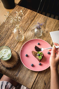 High angle view of hands preparing food on table