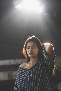 Young woman standing in abandoned building