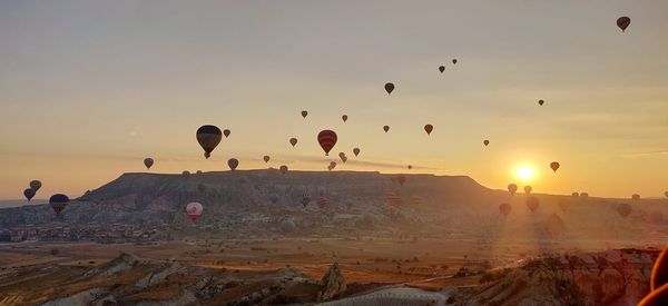 Hot air balloons flying in sky during sunset
