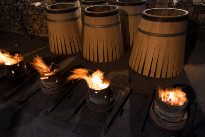 Fire burning amidst barrels