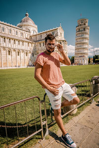 Man standing against leaning tower of pisa