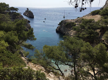 High angle view of sea and trees against sky