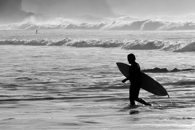 Full length of man on beach against sky