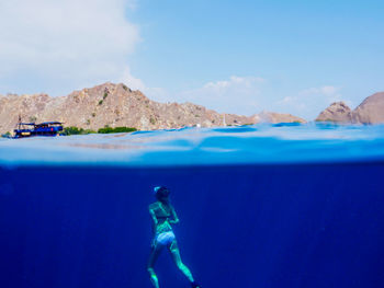 Young woman swimming underwater