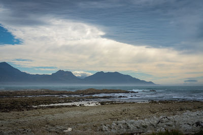 Scenic view of sea and mountains against sky