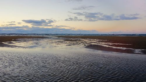 Scenic view of beach against sky during sunset