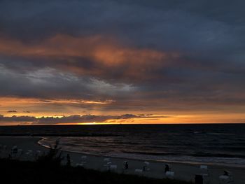 Scenic view of beach against sky during sunset