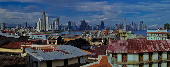 Panoramic view of buildings in city against sky