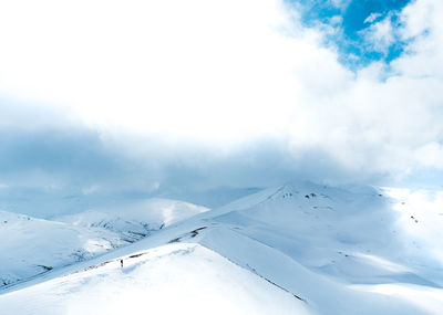 Scenic view of snow covered mountains against sky